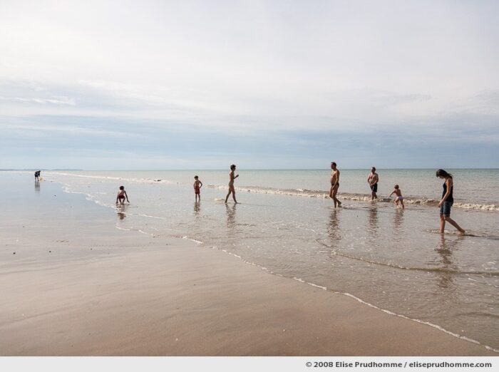 A family of September bathers at low-tide, Hauteville-sur-Mer, France, 2008 by Elise Prudhomme
