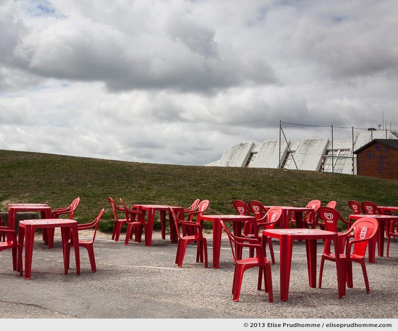 Red plastic tables and chairs "Miko" at a seaside cafe, Tourlaville, France, 2013 by Elise Prudhomme