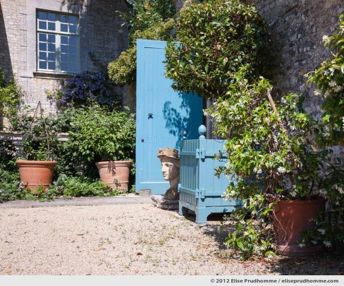 Garden sculpture and door detail, Brecy Castle Gardens, Saint Gabriel Brécy, France, 2012 (series Notable Gardens of France) by Elise Prudhomme.
