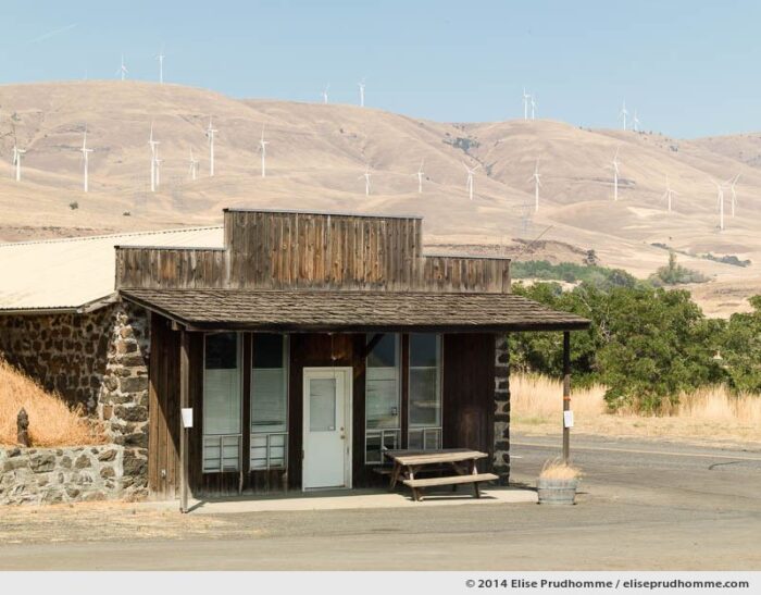 Wind farm and country store, Stonehenge Memorial, Maryhill, Washington, USA, 2014 (series Wild Wild West) by Elise Prudhomme.