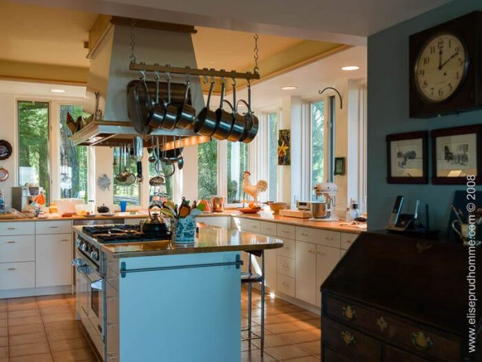 Photo of classical kitchen interior with Techline cabinets and cooking island by Elise Prudhomme.