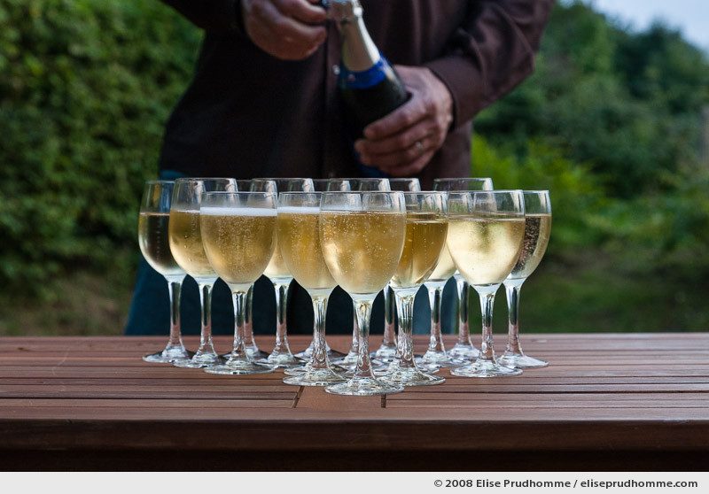 Glasses of champagne outside on a teck garden table, Normandy, France, 2008 by Elise Prudhomme