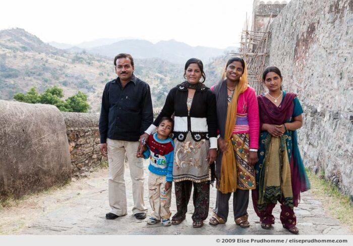 An Indian family posing for a portrait while visiting Kumbalgarh Fort, India, Rajasthan, Northern India, 2009 by Elise Prudhomme.