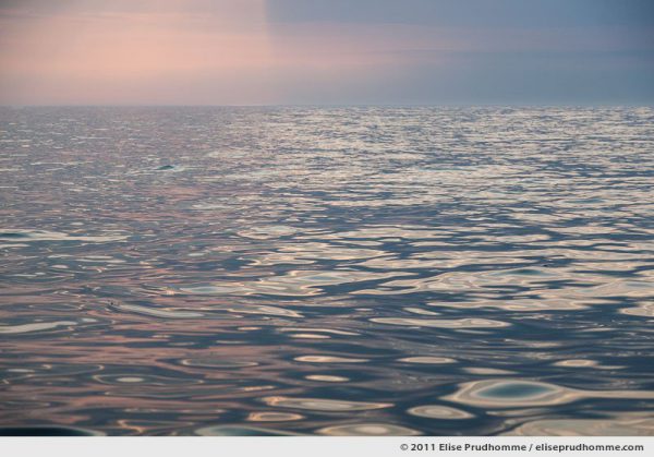 Dusk on a calm and glassy sea, English Channel, Normandy, France, 2011 by Elise Prudhomme.
