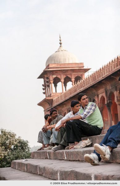 Four men waiting for prayer time at the steps of Jama Masjid, Old Delhi, India, 2009 by Elise Prudhomme.