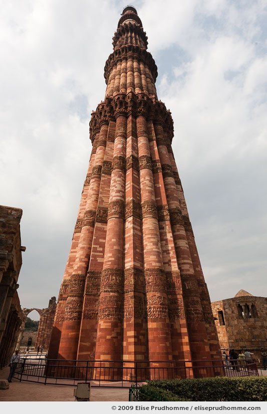 Low angle full vertical view of Qutub Minar tower under cloudy skies, Delhi, India, 2009 by Elise Prudhomme.