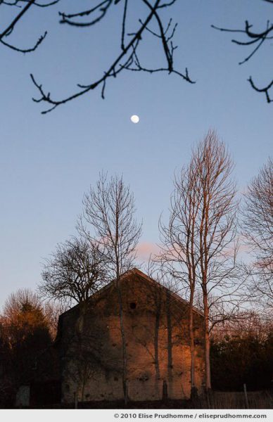 Moonrise over a farmhouse in the village of Saint-Ours-les-Roches, Auvergne, France, 2010 by Elise Prudhomme.