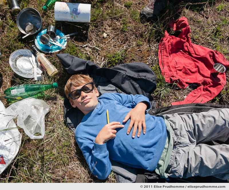 Overhead view of a young boy sleeping after a picnic, Fermanville, France, 2011 by Elise Prudhomme.