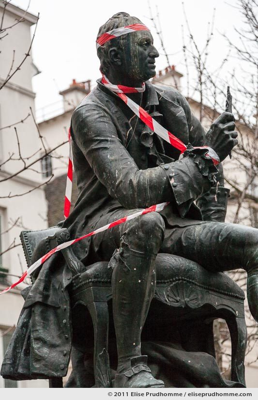 Statue of Denis Diderot by Jean Gautherin in red tape, Paris, France, 2011 by Elise Prudhomme.