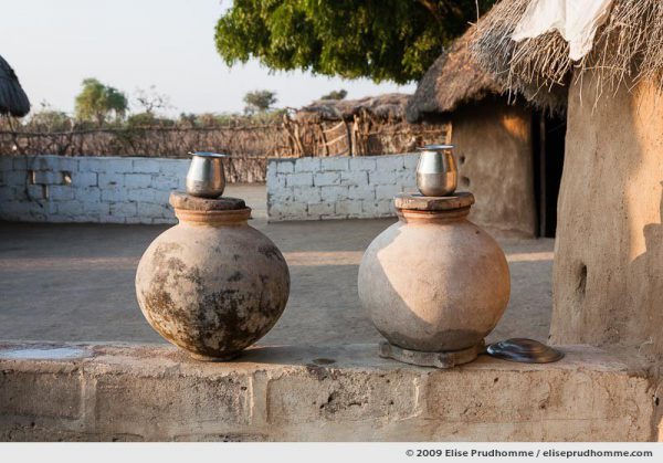Terra cotta water jars and metal cups in a Bishnoi tribal village near Rohet, Rajasthan, Northern India, 2009 by Elise Prudhomme.