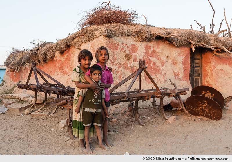 Three children at sunset in Hindu Brahman high caste village of Dhudaly, Rajasthan, Northern India, 2009 by Elise Prudhomme.