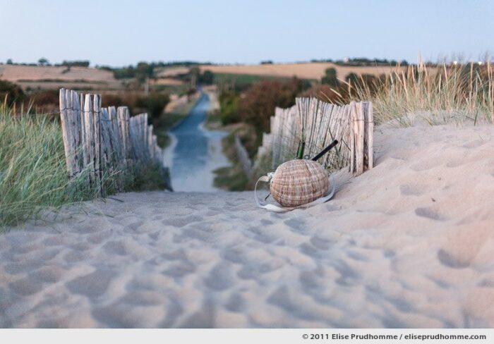 Sunset on a wicker fishing basket left on a beach path, Montmartin-sur-Mer, France, 2011 by Elise Prudhomme.