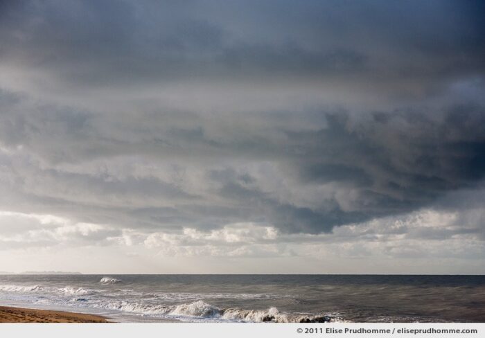 Winter seascape with Granville in the distance, Havre de la Vanlée, France, 2011 by Elise Prudhomme.