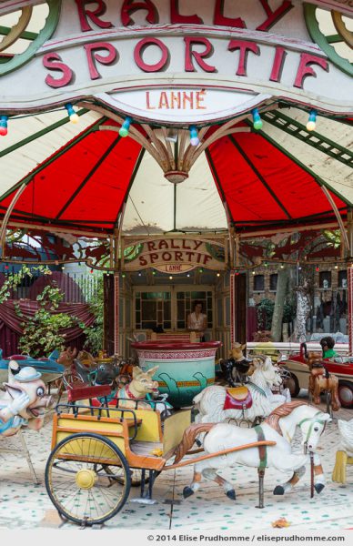 Vertical view of an ancient Merry-Go-Round Rally Sportif Lanné at the Museum of Fairground Arts in Paris, France.