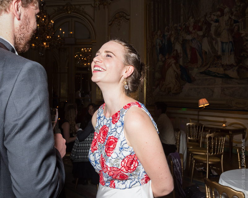 The bride laughs happily during her wedding reception at the Cercle de l'Union Interalliée, Paris, France.