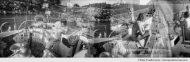 Black and white photograph of people on a sailboat, Cyclades, Greece. Analog photography series entitled Lieux-dits by Elise Prudhomme.