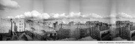 Black and white panoramic photograph of Parisian rooftops and sky, Paris, France. Analog photography series entitled Lieux-dits by Elise Prudhomme.