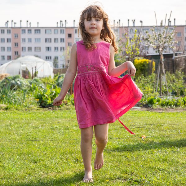 A young girl playing in the garden at the Sensitive Zone during a presentation by guest speaker Gilles Clement at the Sensitive Zone - Urban Farm of Saint-Denis on 9 April 2019.