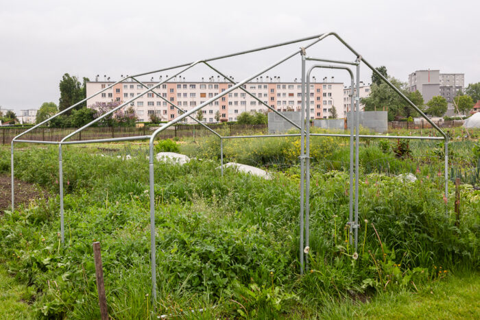 Greenhouse framework in the garden of the Sensitive Zone, Seine-Saint-Denis.  L'inauguration de la Ferme Urbaine de Saint-Denis le 11 mai 2019.  Zone Sensible / Parti Poétique et la Ferme Ouverte de Saint-Denis.