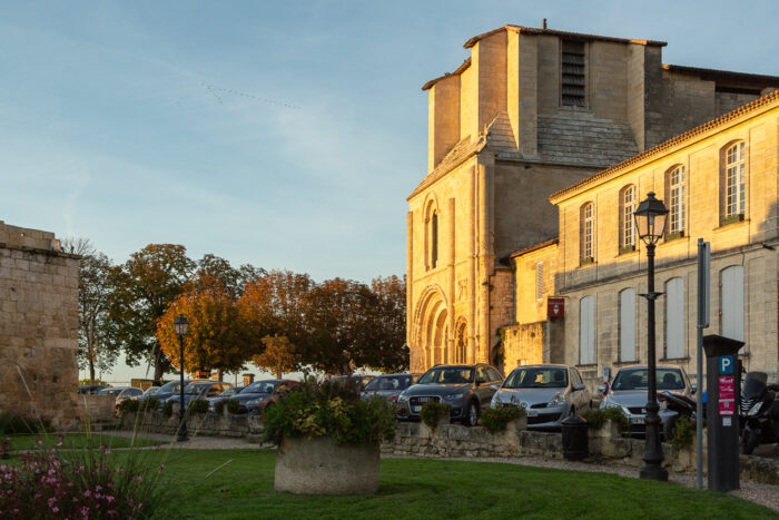 Autumnal facade of the Collegiale Church of Saint-Emilion just before sunset, Bordeaux, Department of the Gironde, France.