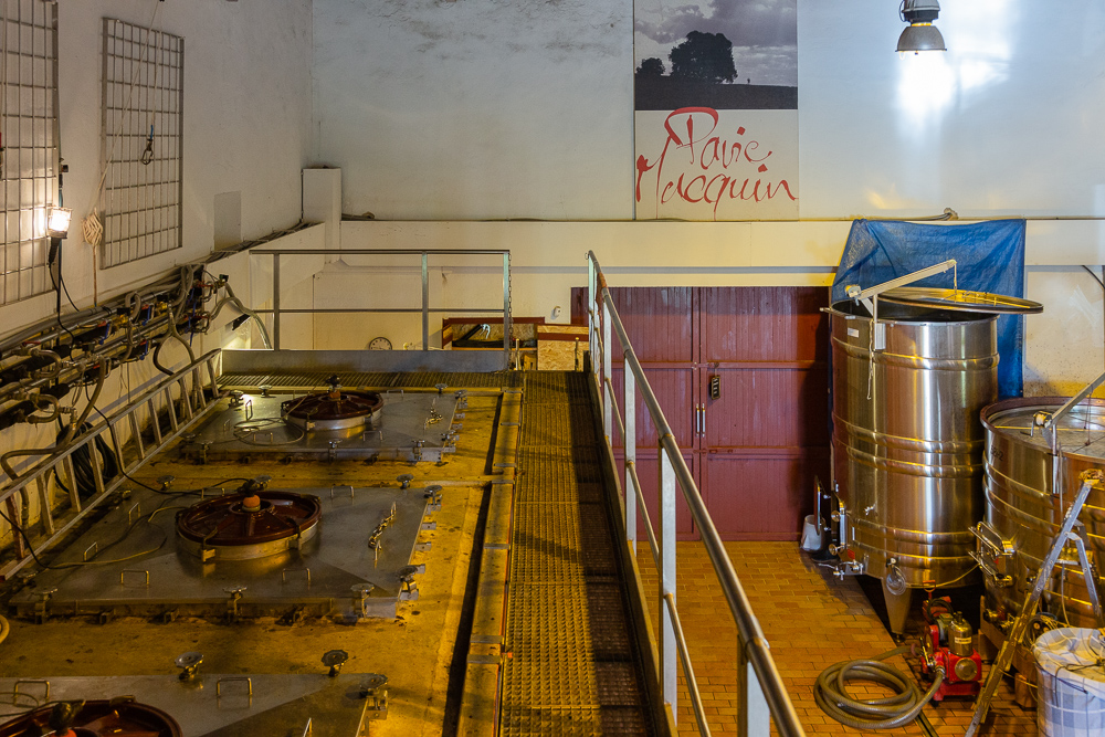 View of the wine production facility standing over the concrete fermentation tanks for Merlot wine, Wine Estate Chateau Pavie Macquin, Saint Emilion, Bordeaux region, Gironde, France.