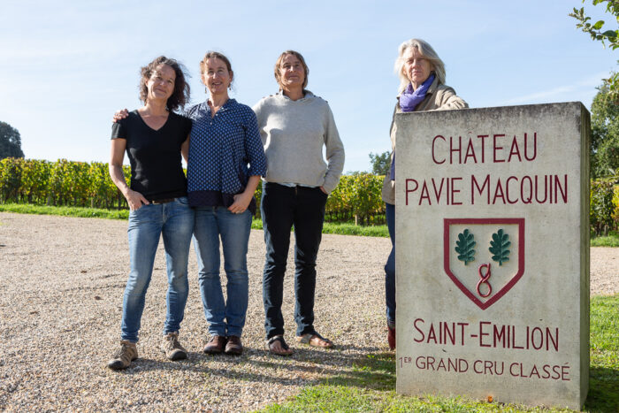Group portrait next to the stele of Chateau-Pavie-Macquin, Saint-Emilion, Gironde, France.