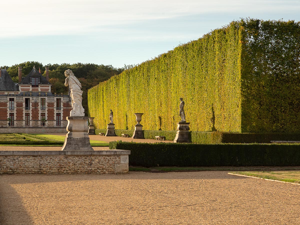 Bordering grove and 17th sculptures, Chateau du Champ de Bataille, Normandy, France