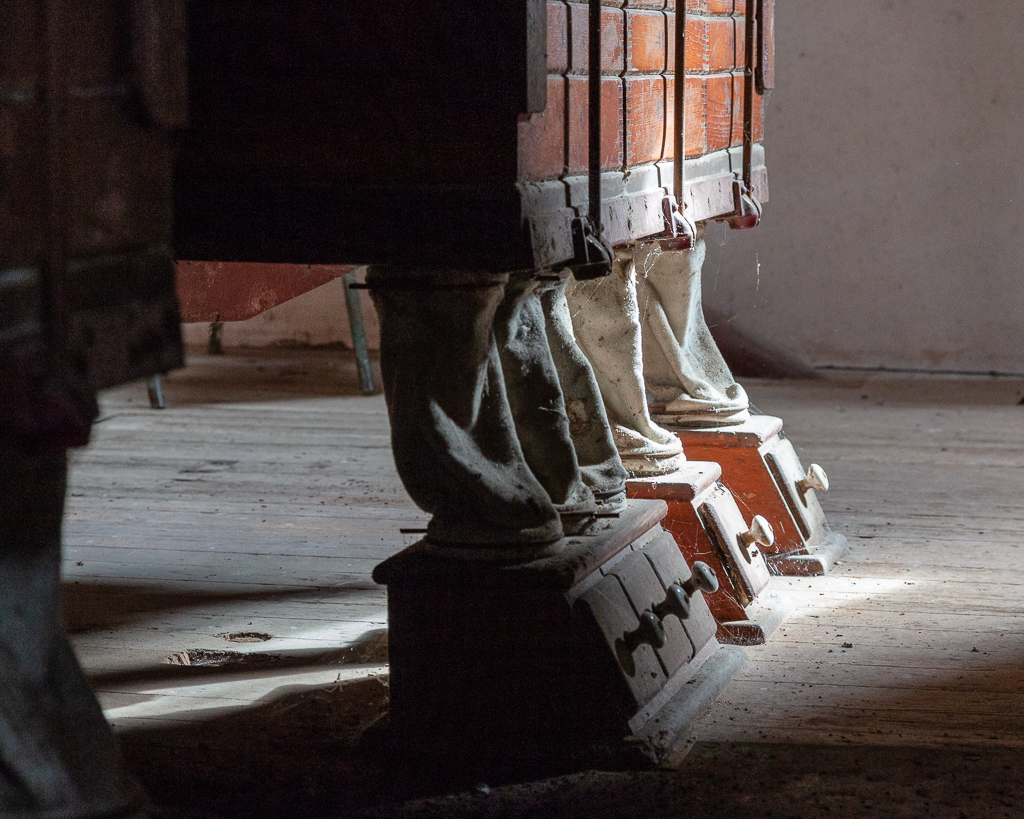 Feet of the plansifters on the top floor of the Saint Gabriel Flour Mill.  Invented by a Hungarian miller at the end of the nineteenth century, plansifters have improved the sifting of flour. Set up in the mill in 1930, these large wooden cabinets animated by a circular movement contain a succession of sieves, wooden frames covered with cloth, crossed by a flour of finer and finer.