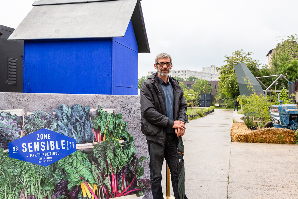 Chief gardener Franck Ponthier standing at the entrance to the Sensitive Zone, Urban Farm of Saint-Denis.   L'inauguration de la Ferme Urbaine de Saint-Denis le 11 mai 2019.  Zone Sensible / Parti Poétique et la Ferme Ouverte de Saint-Denis.