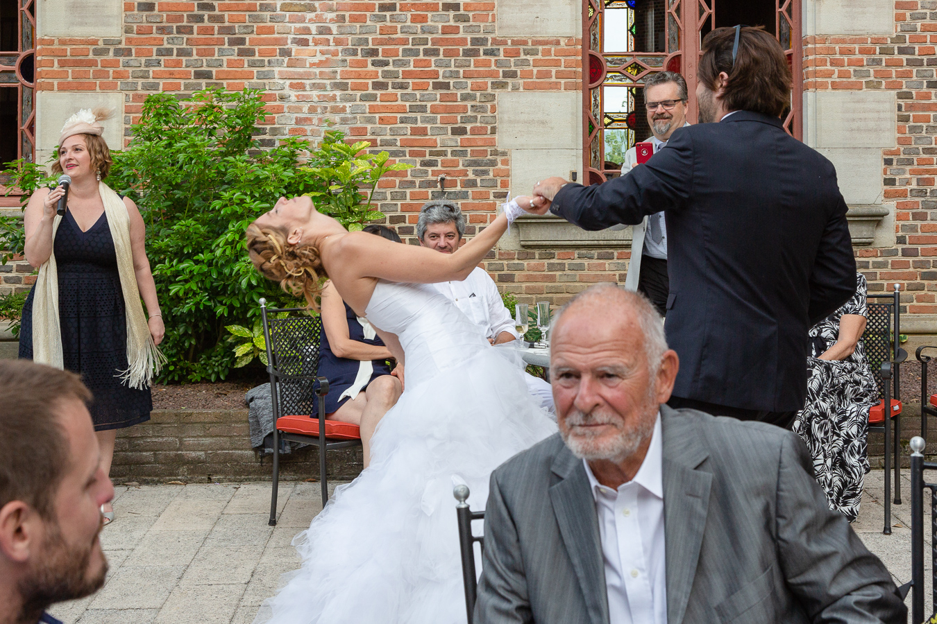 The bride strikes a pose during the entrance waltz with the groom during their Wedding Party Chateau de Maulmont near Vichy, France.