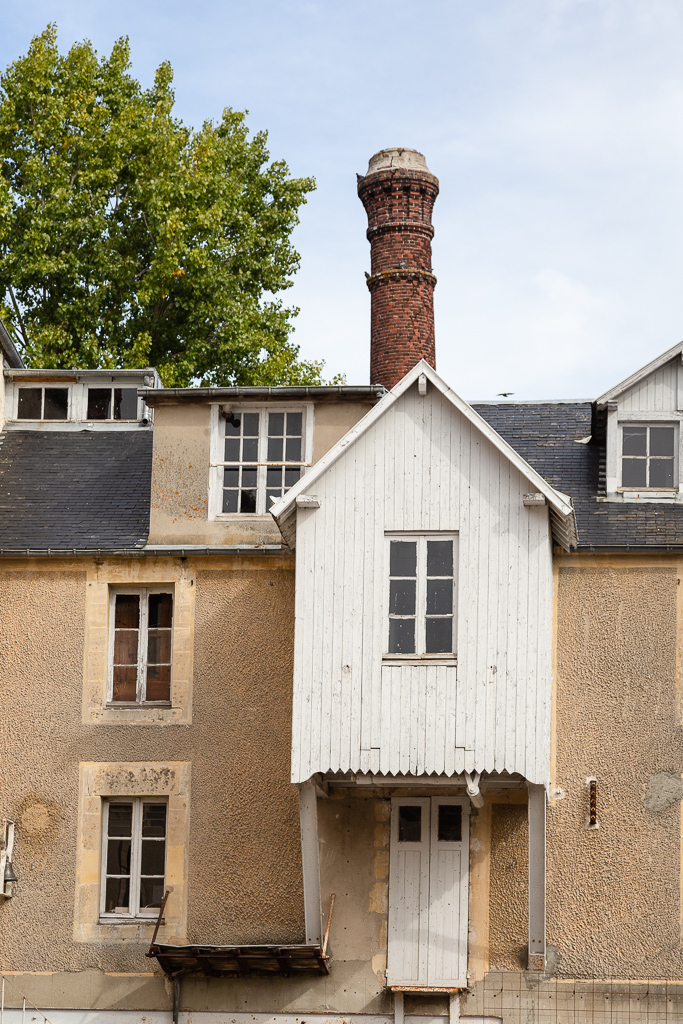 Exterior chimney and façade of the Saint Gabriel Flour Mill.  Restoration of the Saint-Gabriel Flour Mill, Saint-Gabriel-Brecy, France.