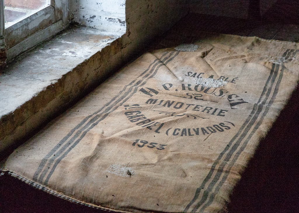 Sack of flour in a factory window of the Saint Gabriel Flour Mill.  Restoration of the Saint-Gabriel Flour Mill, Saint-Gabriel-Brecy, France.